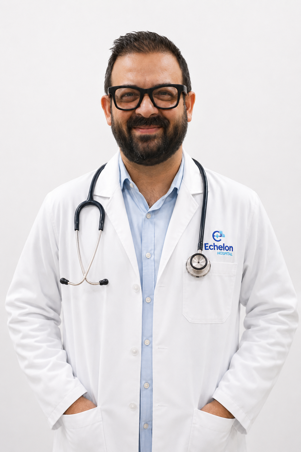 Male doctor wearing a white coat, stethoscope around his neck, blue shirt, smiling, with Echelon Hospital logo visible on the coat pocket.