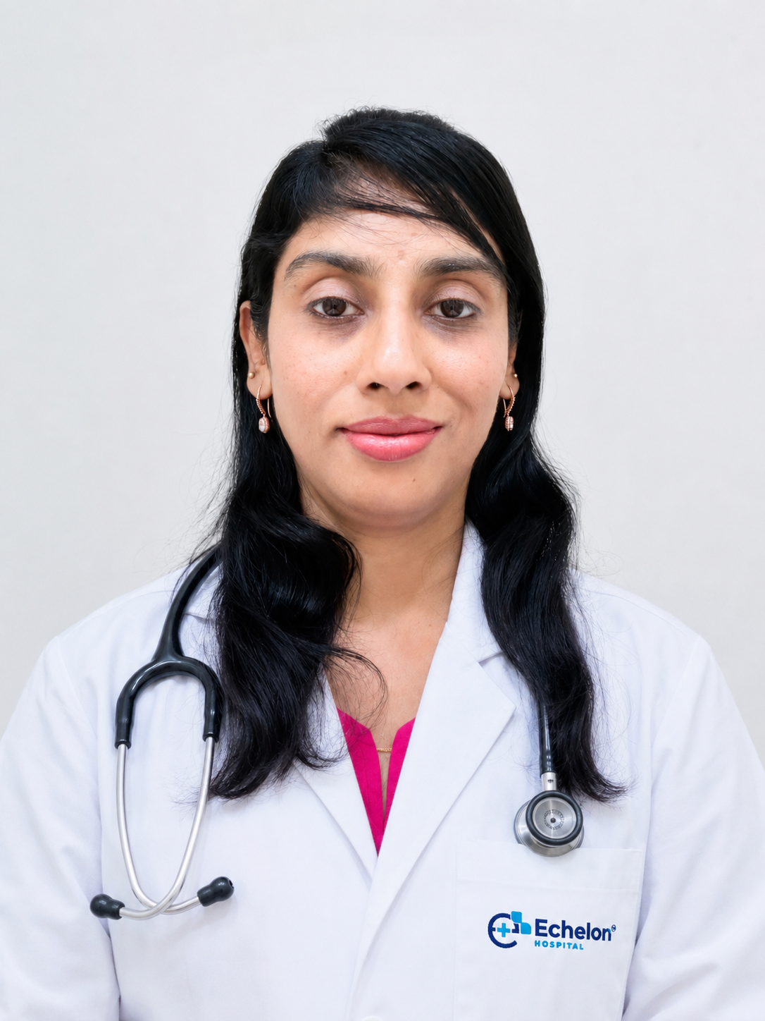 Portrait of a female doctor in a white coat with a stethoscope around her neck, facing the camera; Echelon Hospital logo on her pocket.