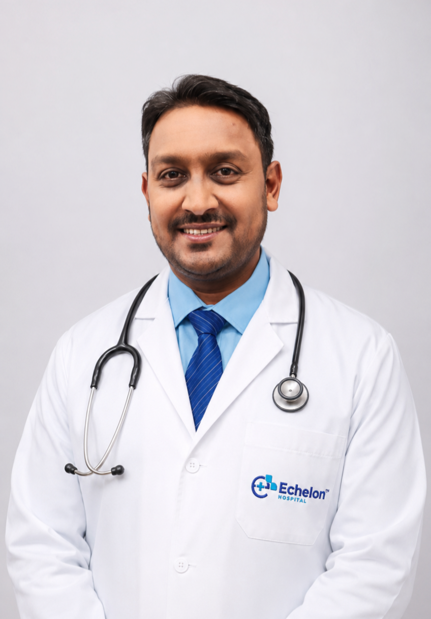 Smiling male doctor in a white coat with a stethoscope, blue shirt and tie, Echelon Hospital logo on the pocket.
