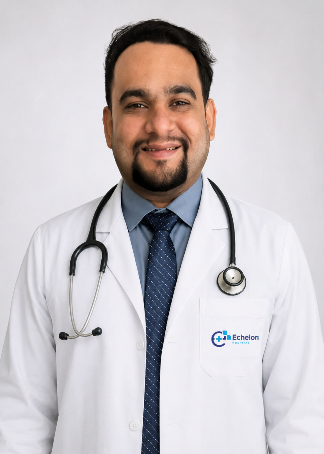 DR.MANAS BHANUSHALI Male doctor in a white coat with stethoscope, smiling, Echelon Hospital logo on the pocket.
