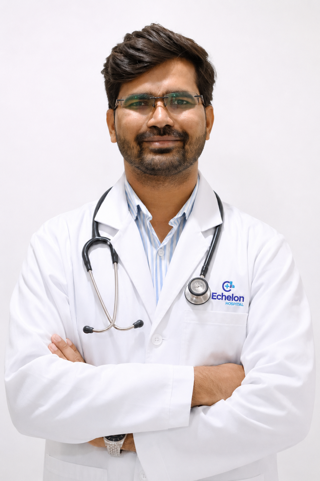 Male doctor with glasses in a white coat, stethoscope around his neck, arms crossed; Echelon Hospital logo on coat pocket visible.