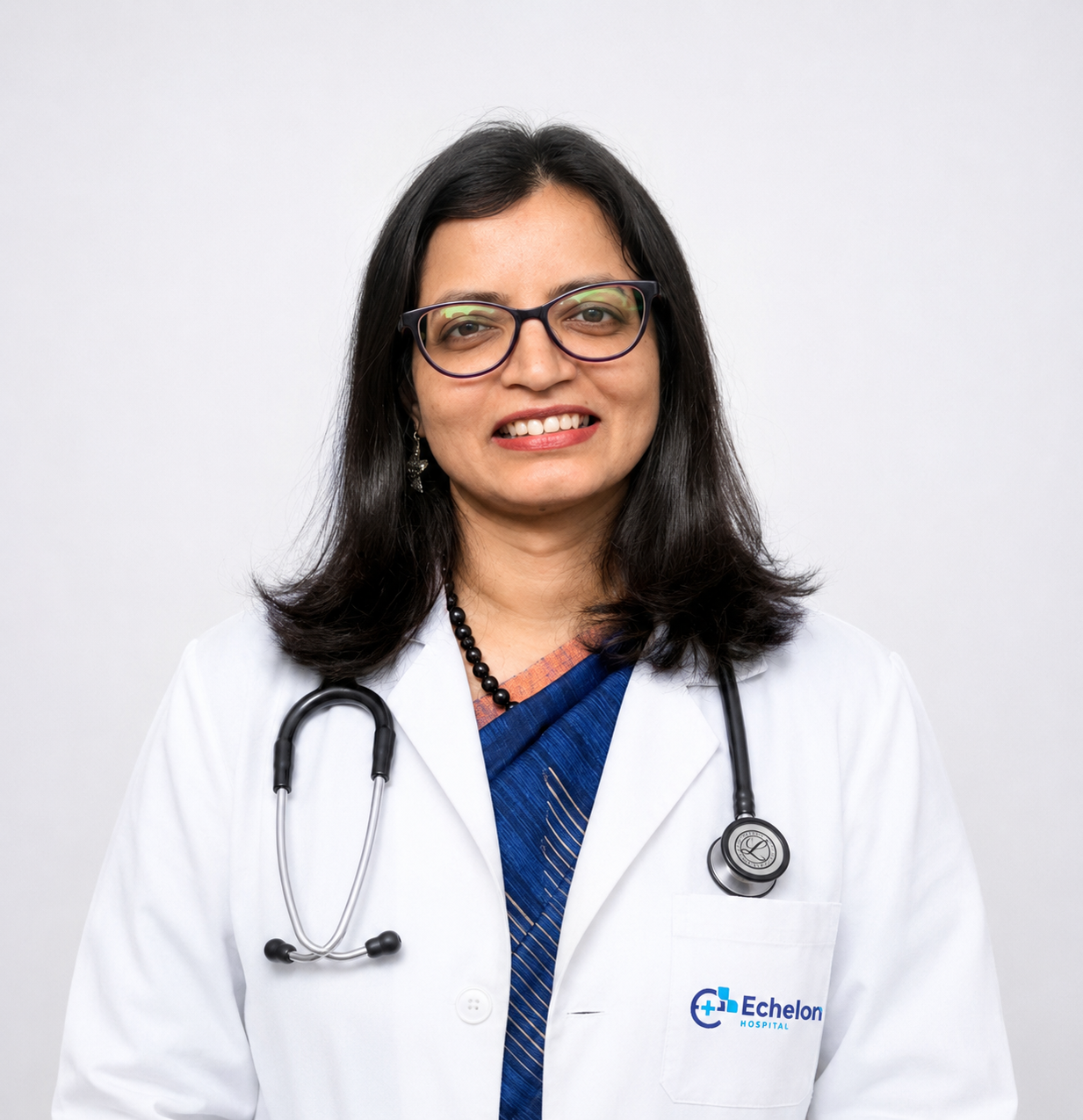 Portrait of a smiling female doctor with glasses, white lab coat, stethoscope, and Echelon Hospital logo visible against a light background.