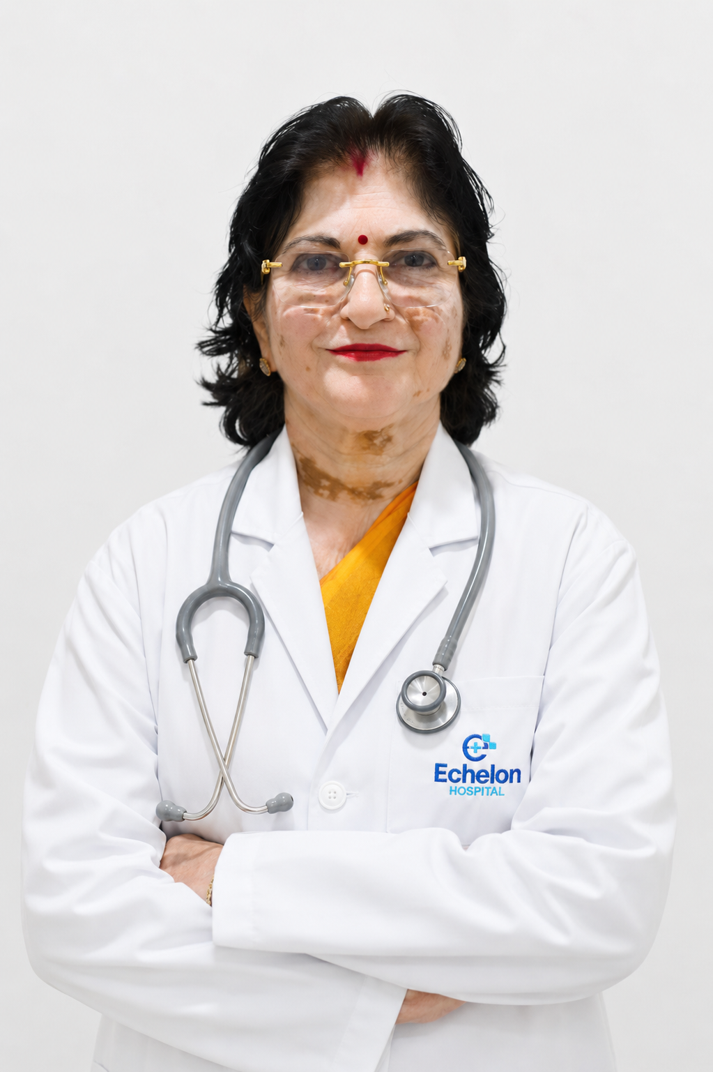 Female doctor in a white coat with stethoscope, arms crossed, wearing gold glasses and red lipstick; Echelon Hospital logo on her coat.