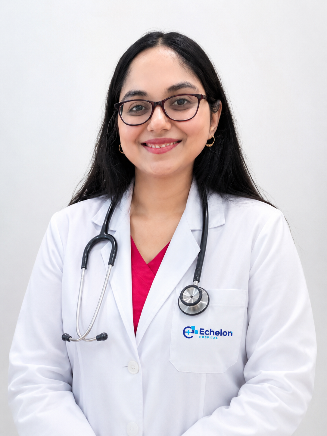 Smiling female doctor with glasses in a white lab coat, stethoscope around her neck, standing against a light background.