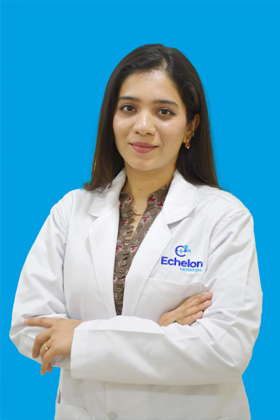 Female doctor in a white lab coat with arms crossed against a bright blue background.