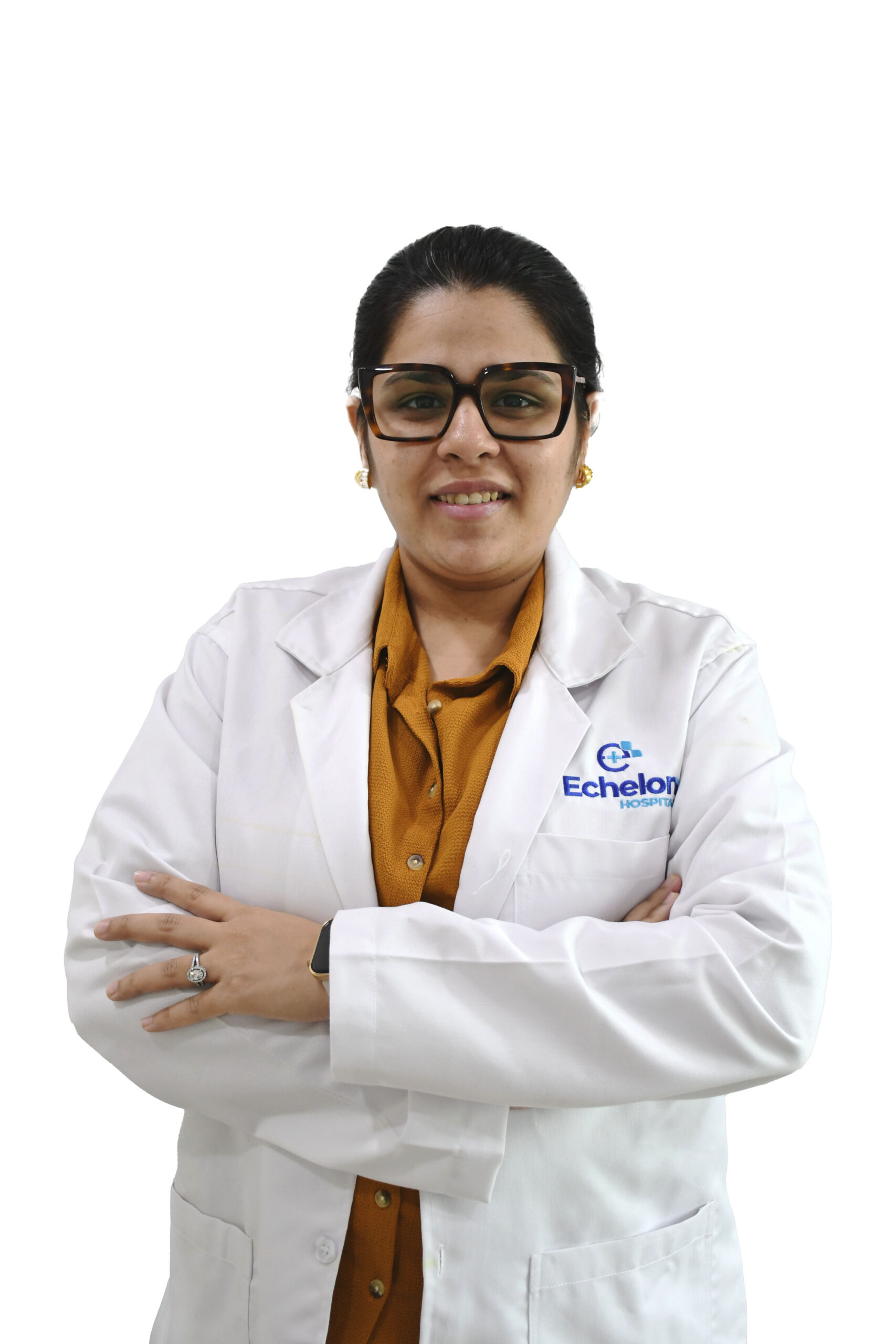 Healthcare professional in a white lab coat and orange shirt, arms crossed, smiling; Echelon Hospital logo on coat.
