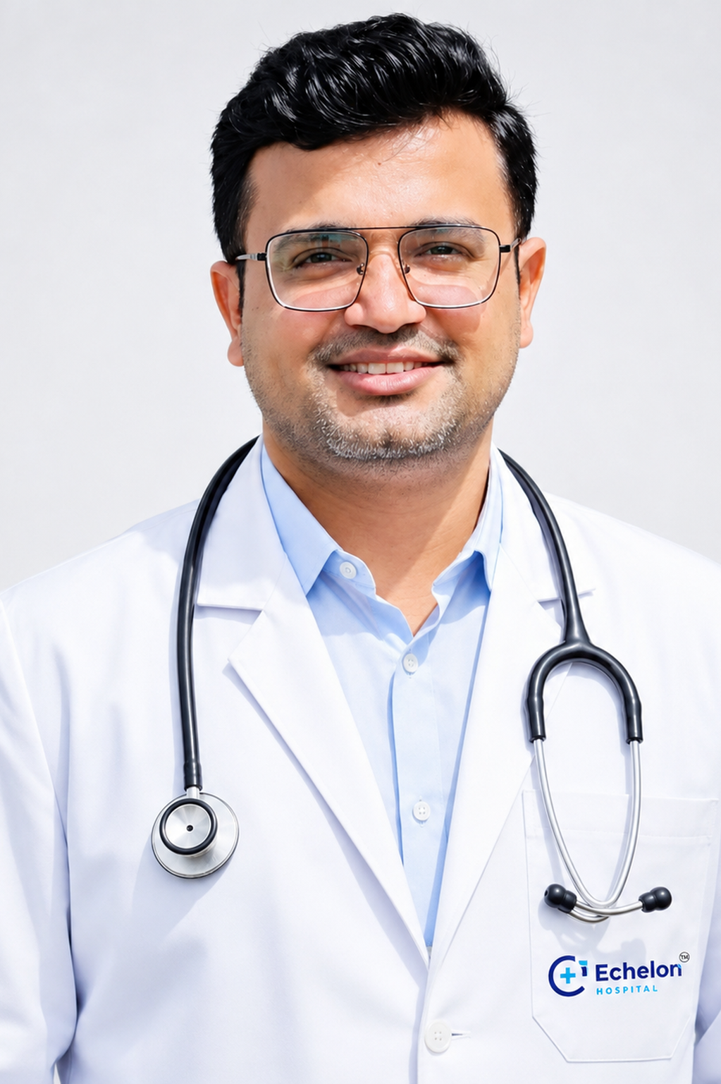 Male doctor in a white coat with stethoscope, smiling, Echelon Hospital logo on the pocket.