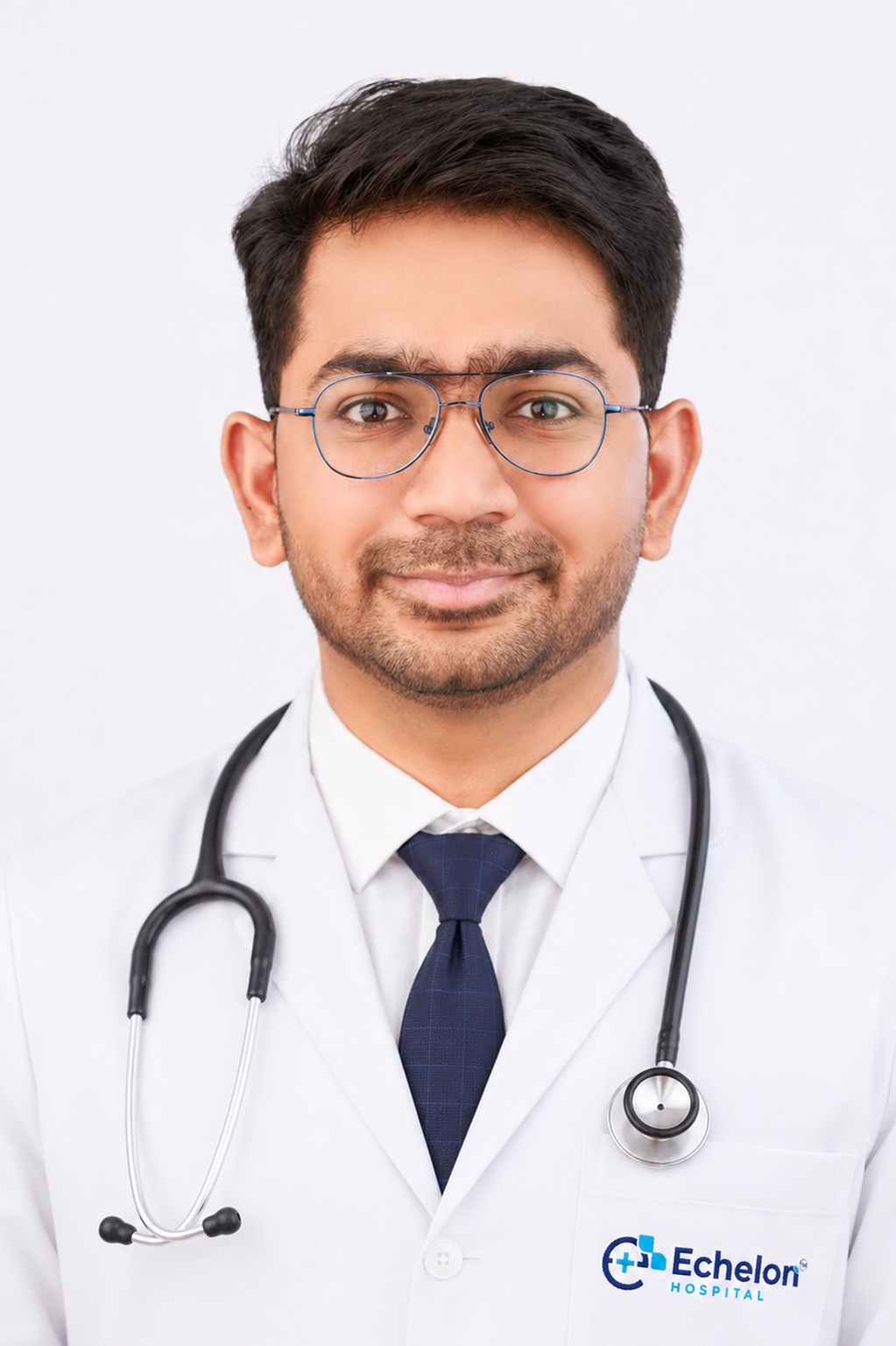 Portrait of a smiling male doctor with glasses in a white coat, stethoscope around his neck, Echelon Hospital logo visible on the pocket