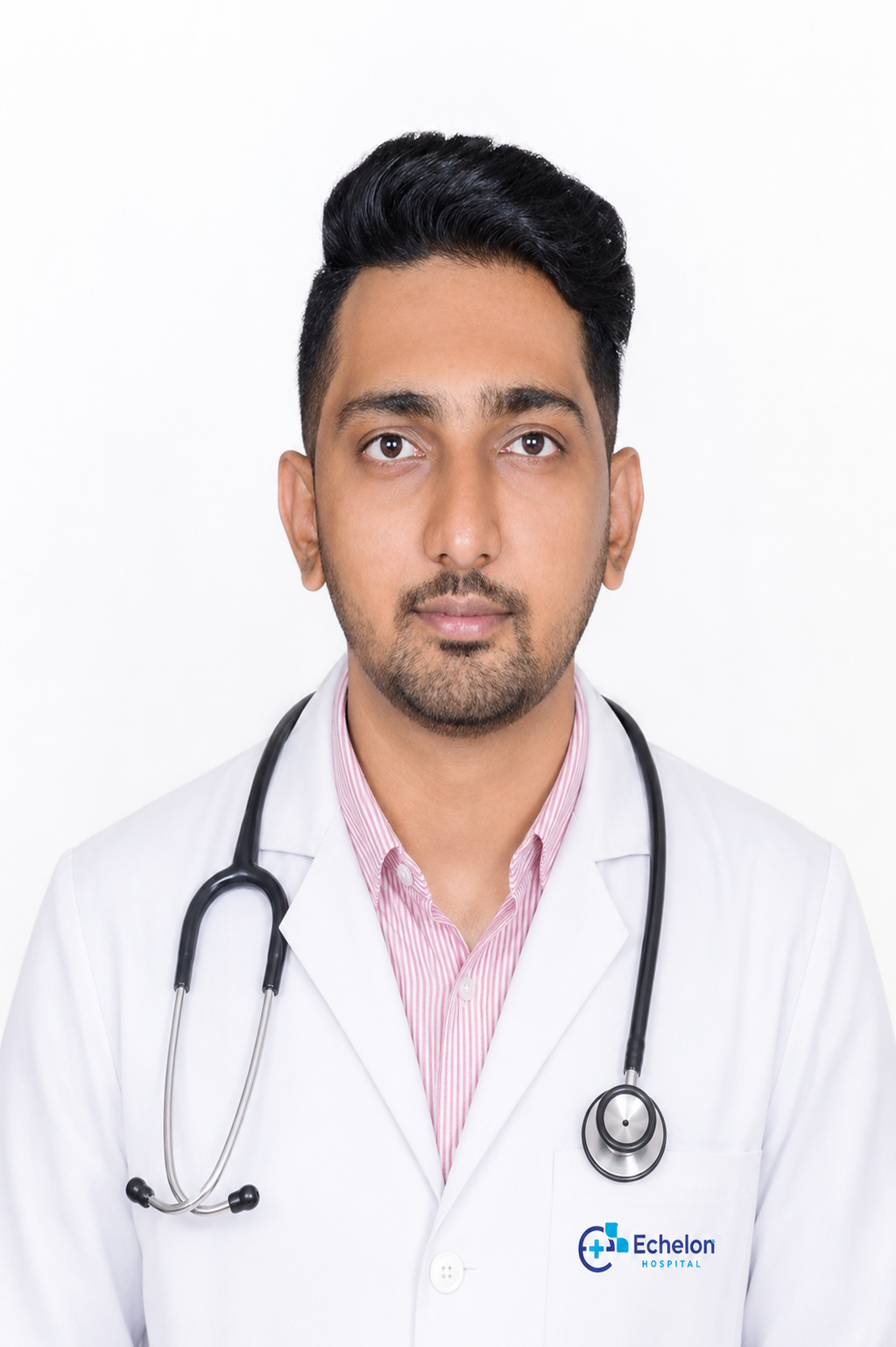 Male doctor in a white coat with stethoscope around his neck, facing the camera; Echelon Hospital logo on pocket.