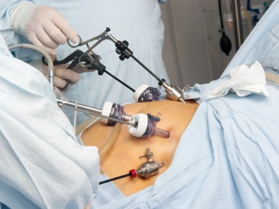 Cupped hands cradle a glowing blue illustration of kidneys showing internal structures in front of a medical backdrop
