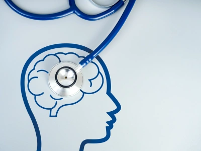 Blue stethoscope over a line-art profile of a head with a brain, symbolizing brain health care.