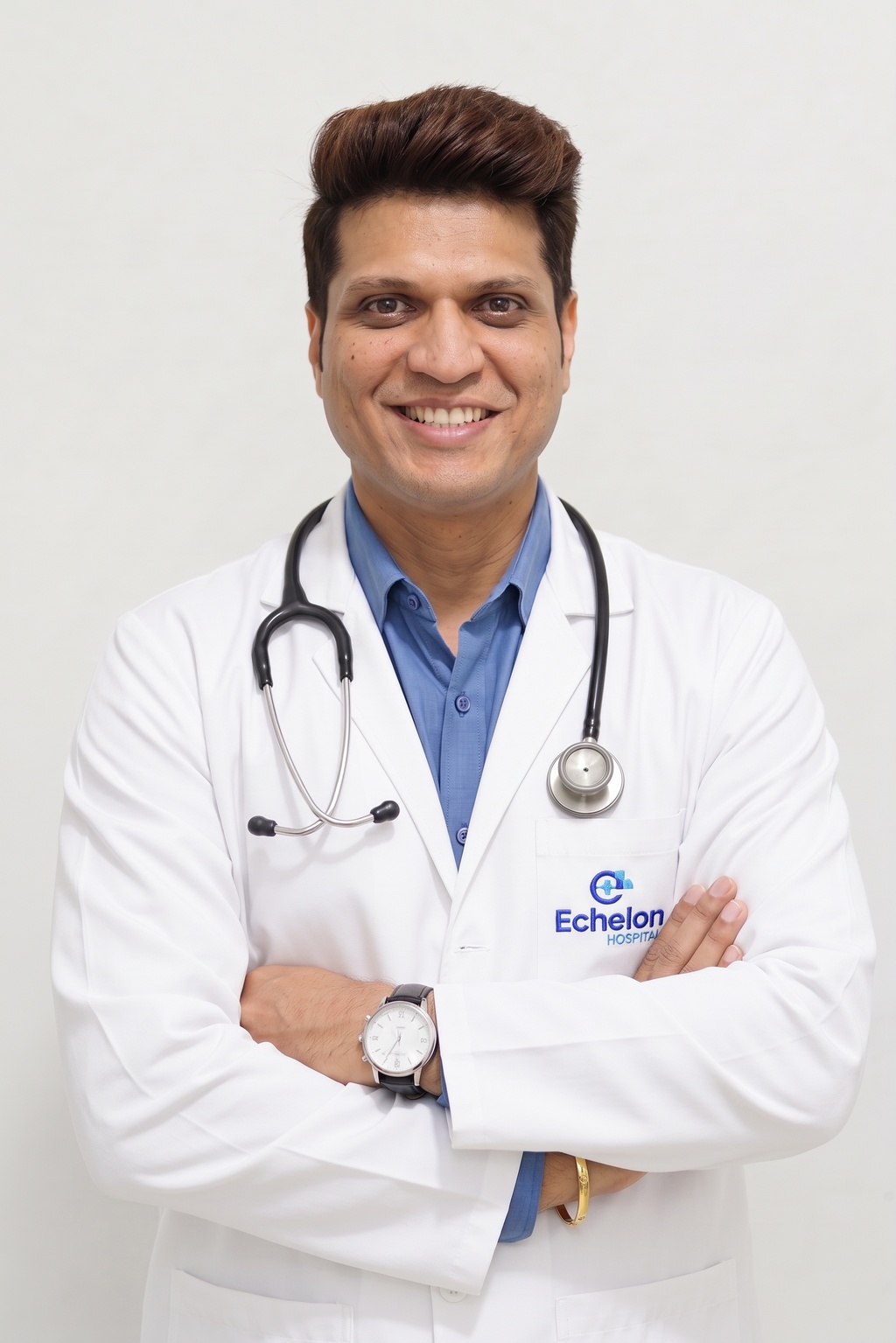 Male doctor in a white coat with stethoscope around his neck, wearing glasses, smiling, Echelon Hospital logo on pocket.